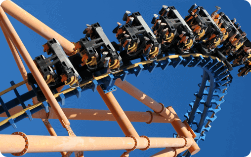 A roller coaster ride on a blue sky.