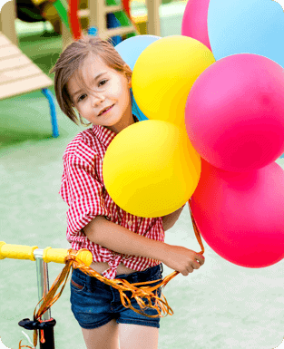 A girl holding balloons.