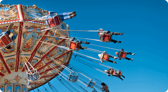 A carousel with people riding on it.