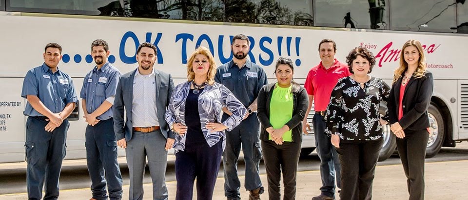 A group of people standing in front of a bus.