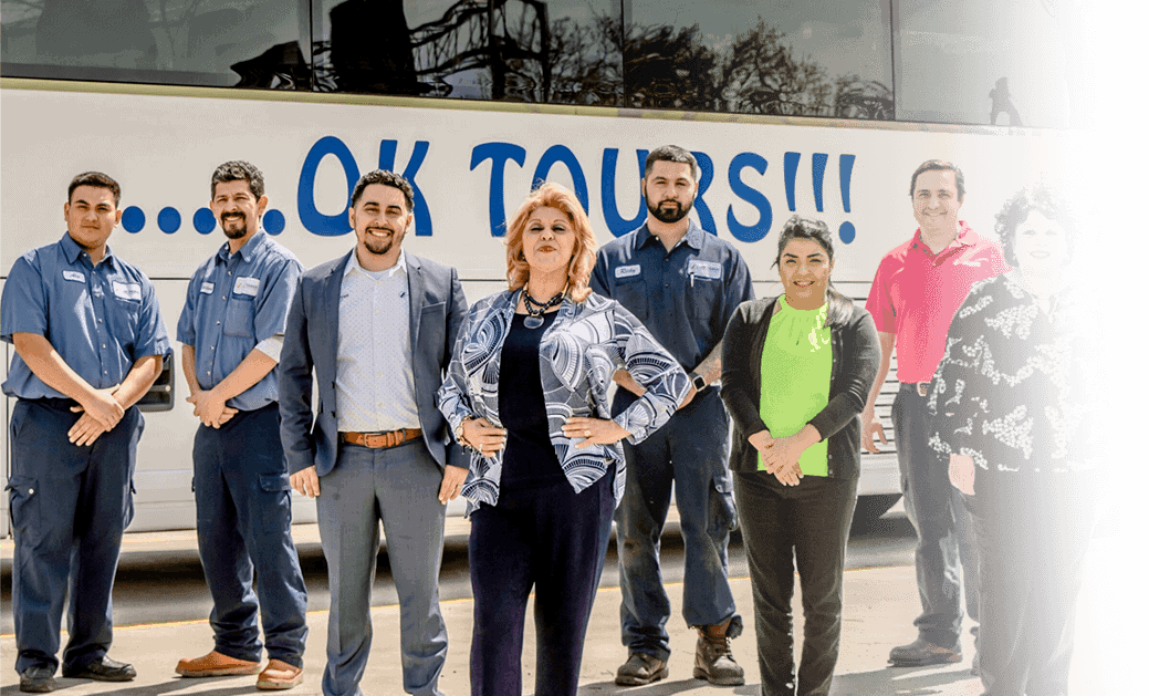 A group of people standing in front of a bus.