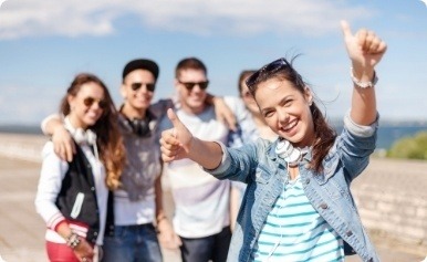 A group of young people giving thumbs up.