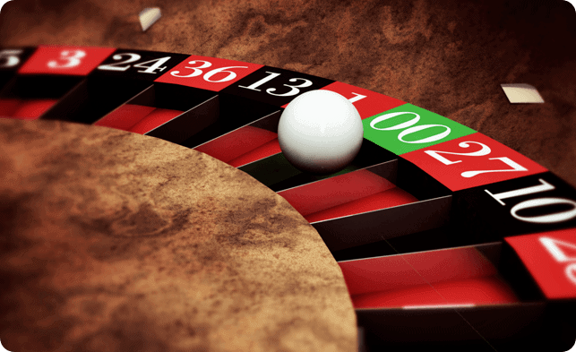 A roule wheel with a white ball on it.