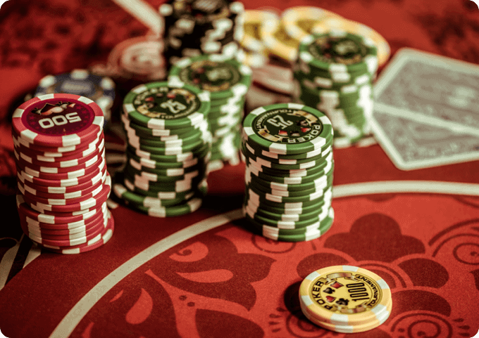A group of poker chips and cards on a table.