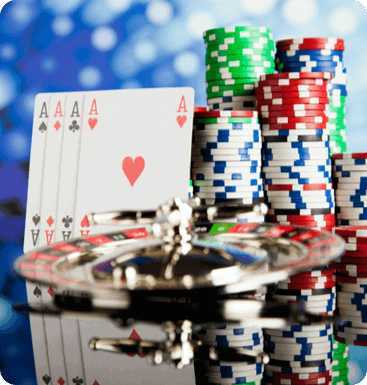 A set of poker chips and cards on a table.