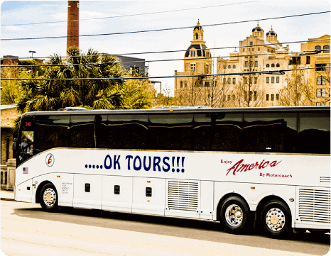 A white bus driving down a street.