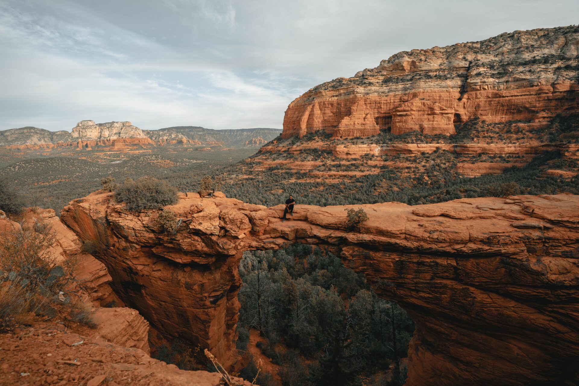 A person standing on top of a cliff in sedona, arizona.