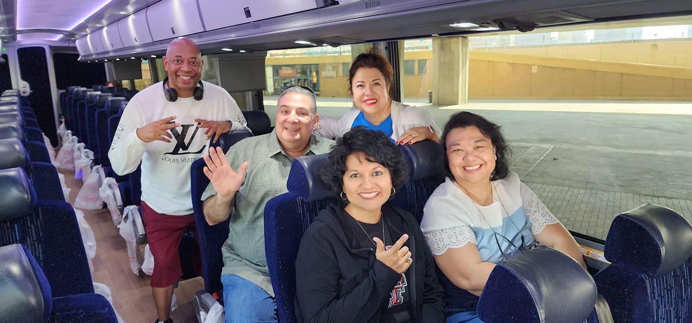 A group of people posing for a photo on a bus.