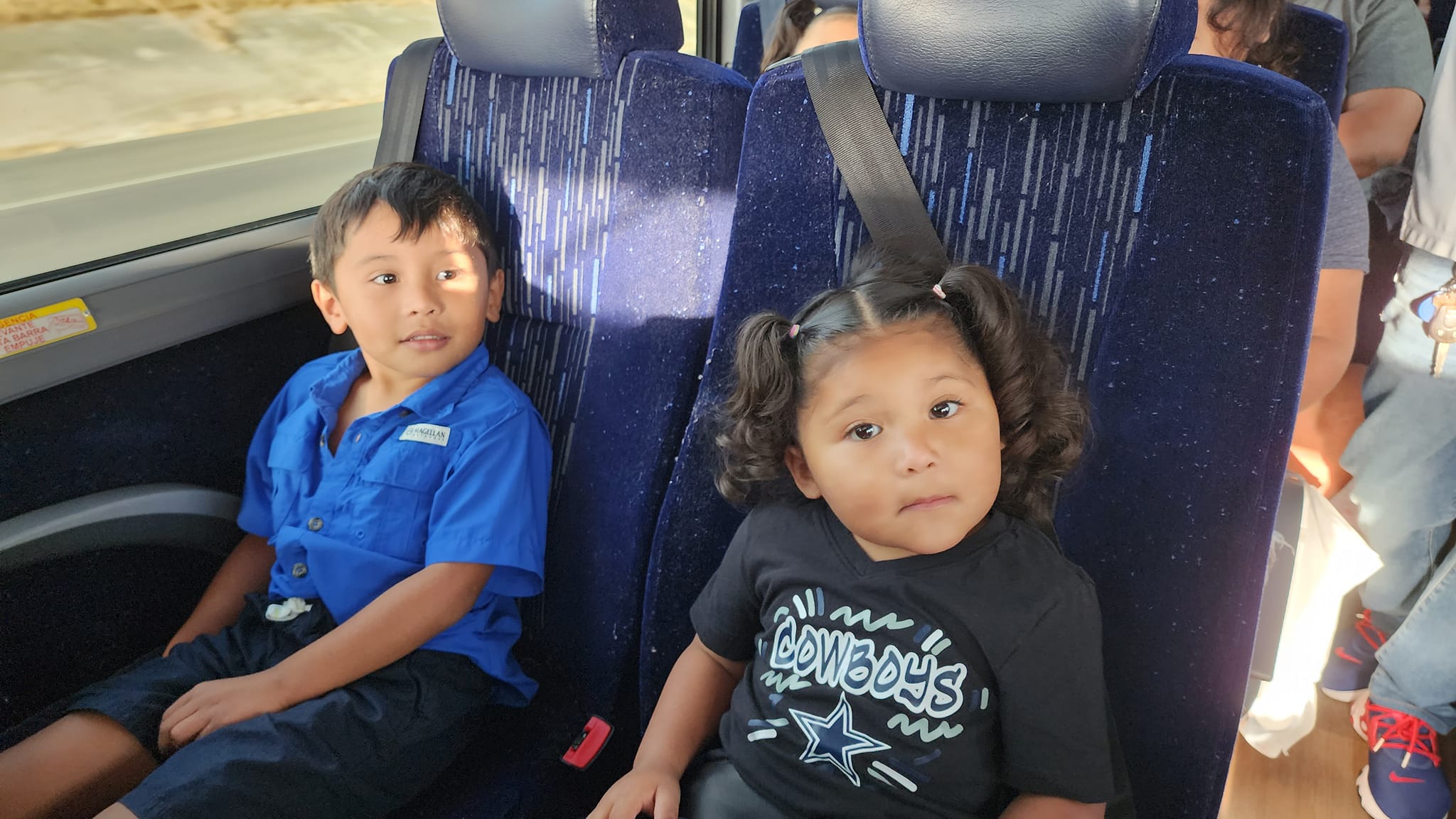 Two children sitting on a bus.